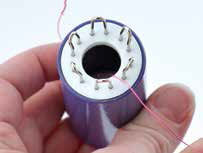 Wire being inserted into knitter